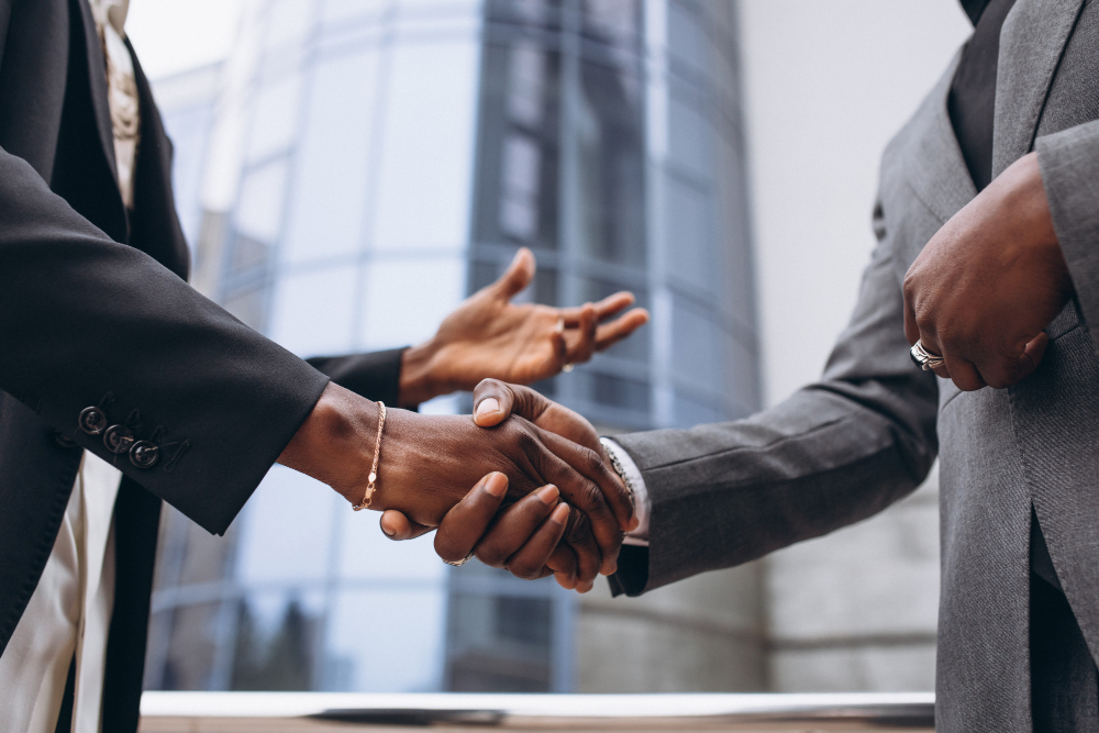 businessmen shake hands with each other